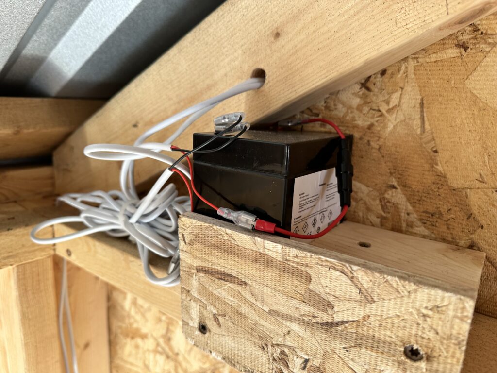 battery pack finside the coop for the automatic solar chicken door 