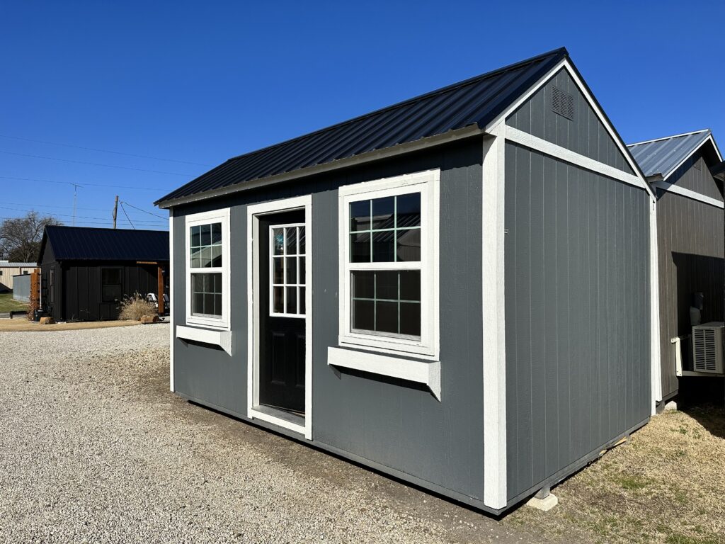dark gray siding, white trim and black metal roof 