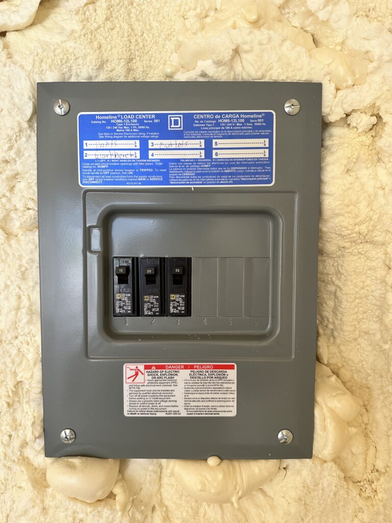 100amp breaker panel on the inside of this metal lofted tall barn