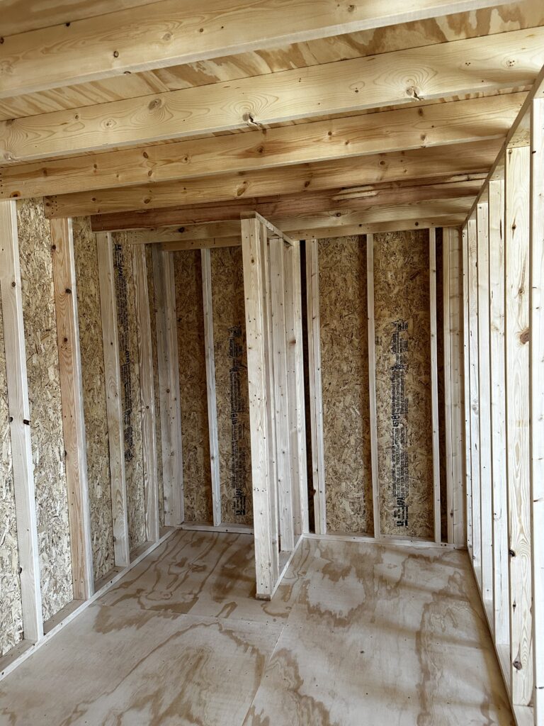 bathroom with space for shower and stackable washer and dryer under loft 